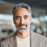 Close up headshot portrait of happy middle aged older professional business man, smiling bearded mature executive ceo manager, older male entrepreneur, rich confident business owner in office.